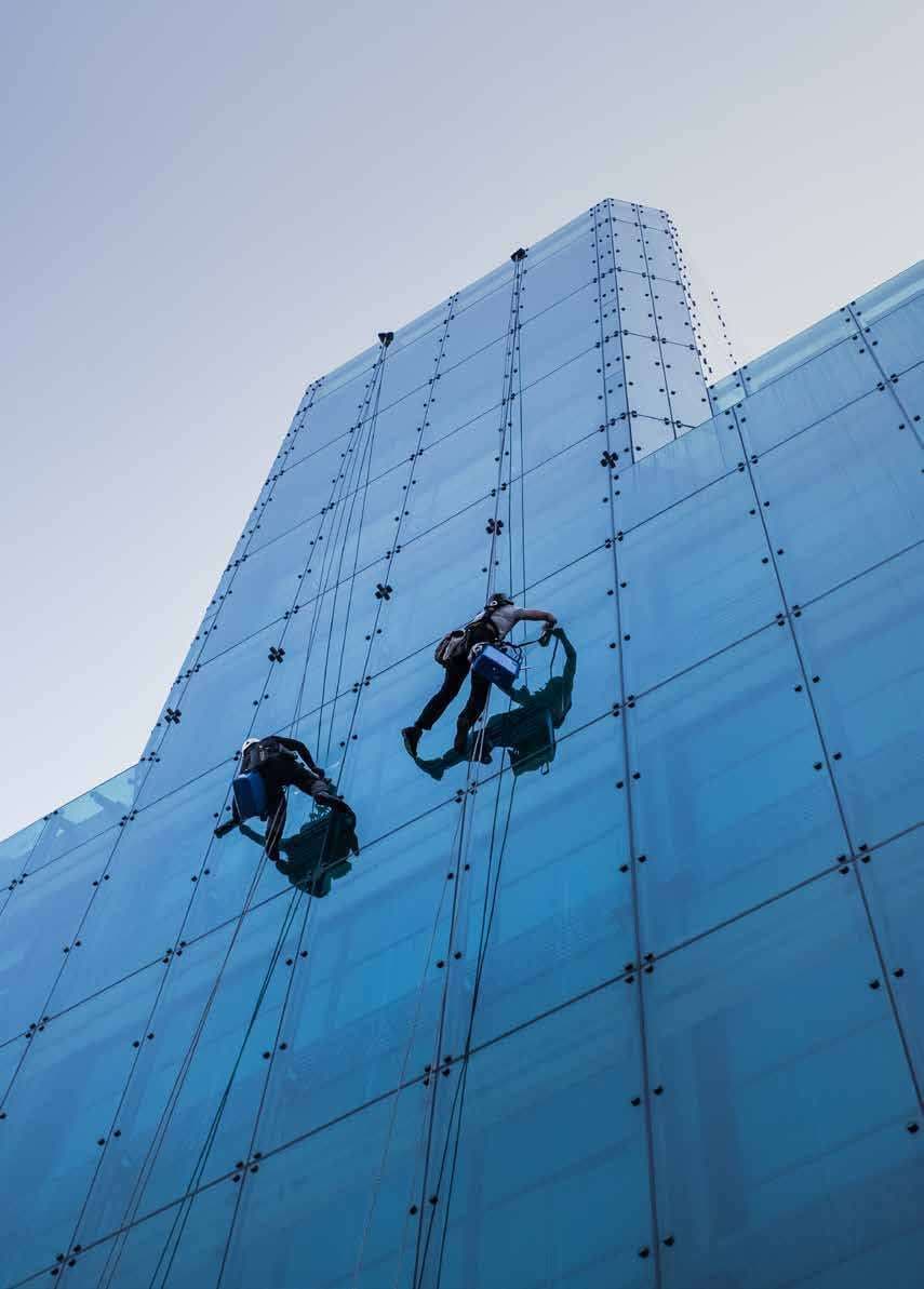 Bitutam rope-access technicians cleaning the glass facade of a high-rise building