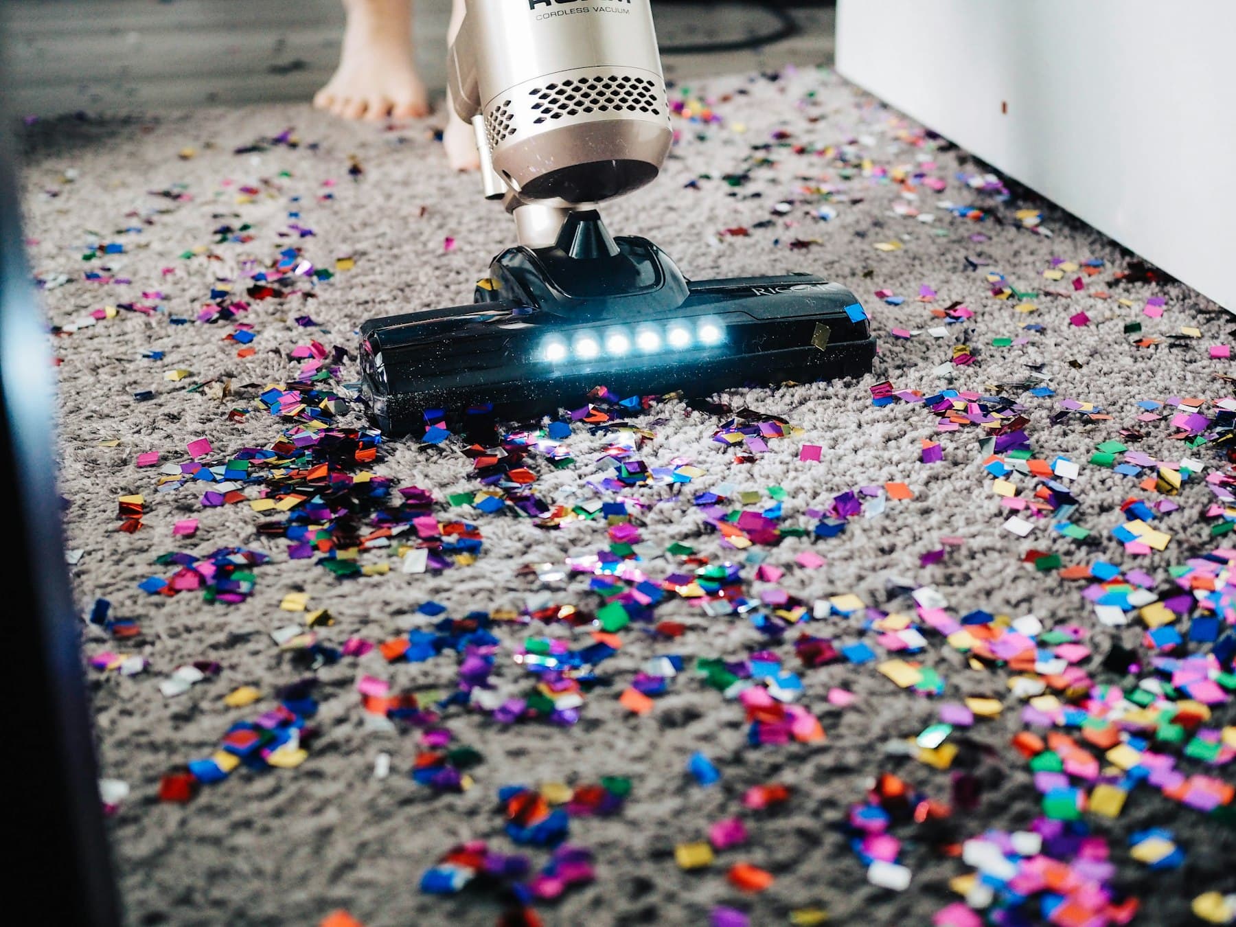 A vacuum cleaner lifting debris from a hard floor